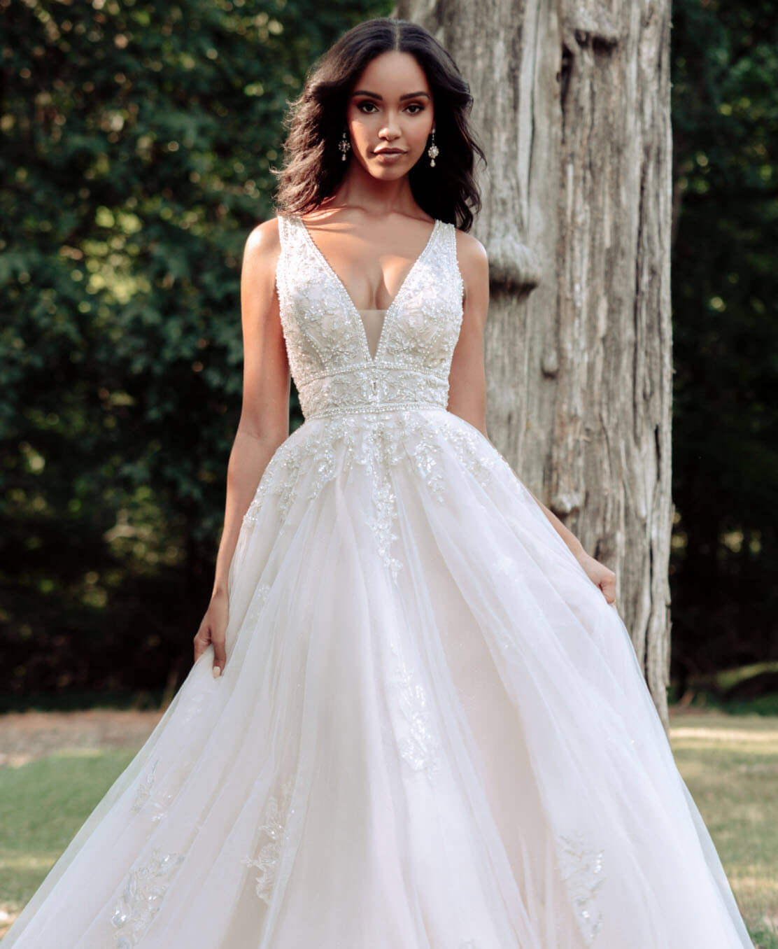Model wearing a white gown by Allure Bridal