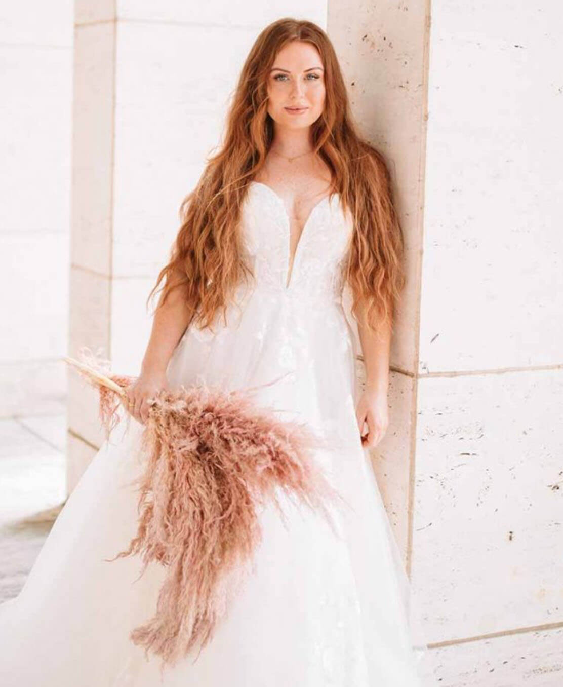 Model wearing a white gown by Stella York. Mobile image