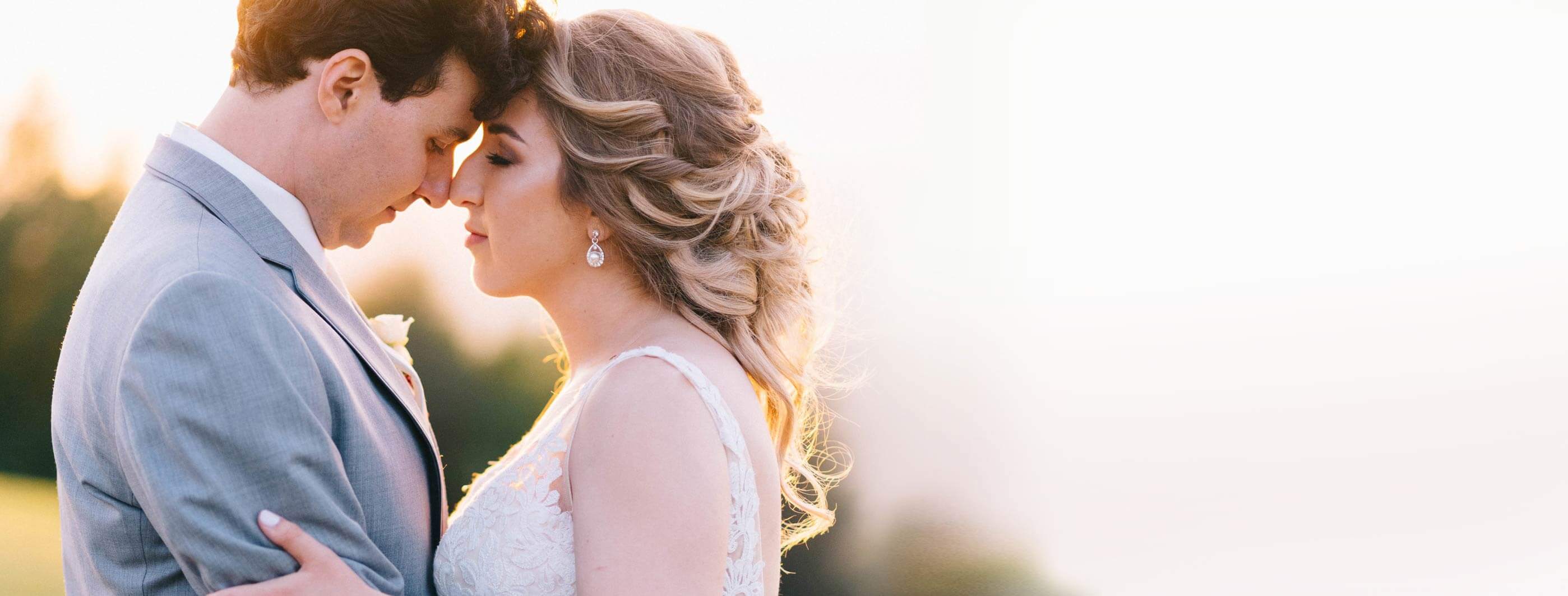 Сouple wearing a white gown and a gray suit