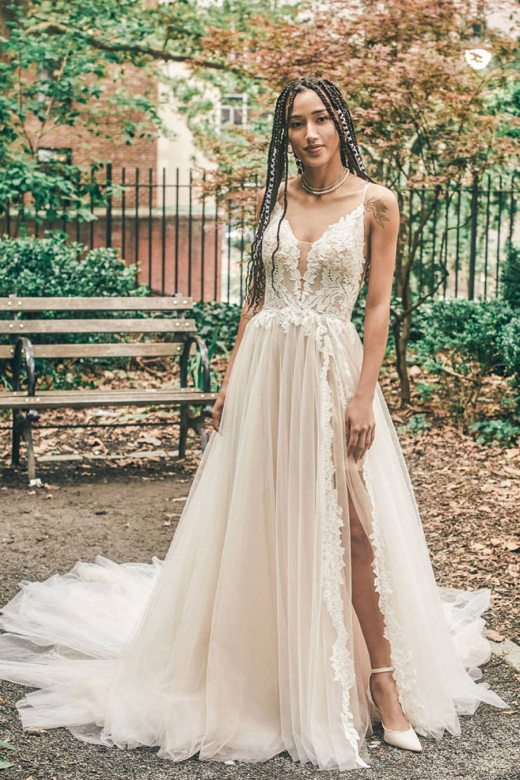 Model wearing a white gown by Madison James